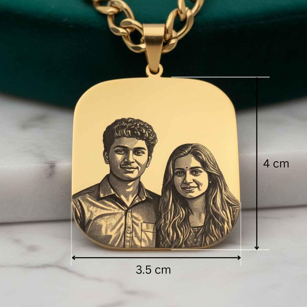 Gold-plated engraved photo necklace, rounded rectangle pendant on a curb chain, front view of the pendant with size marks, 4 cm by 3.5 cm