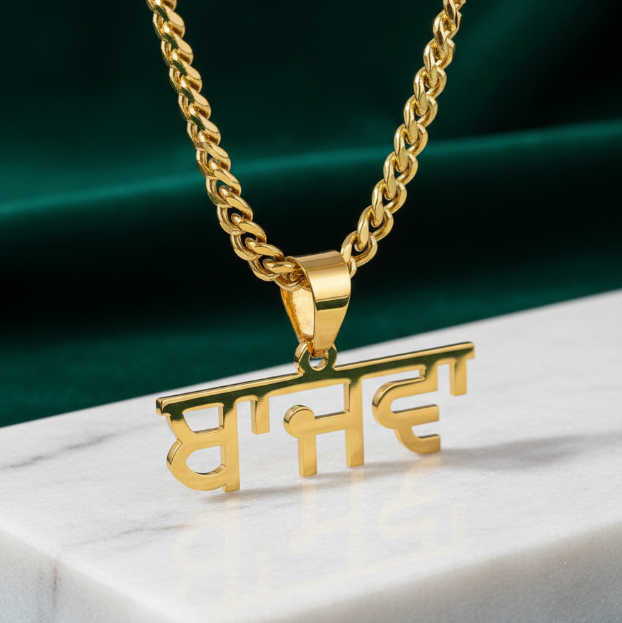 Gold necklace with a pendant on a marble surface