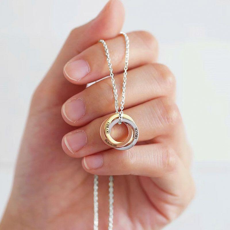 Linked circles necklace: three interlocking rings engraved with names such as 'Dilpreet' and 'Harleen', held in a hand
