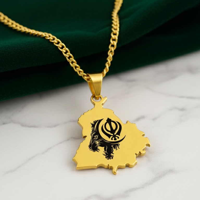 Gold-plated Punjab map pendant with a black Khanda design on a curb chain, on white marble