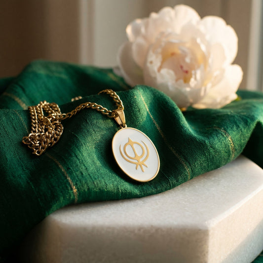 Khanda enamel pendant on green silk with a white flower