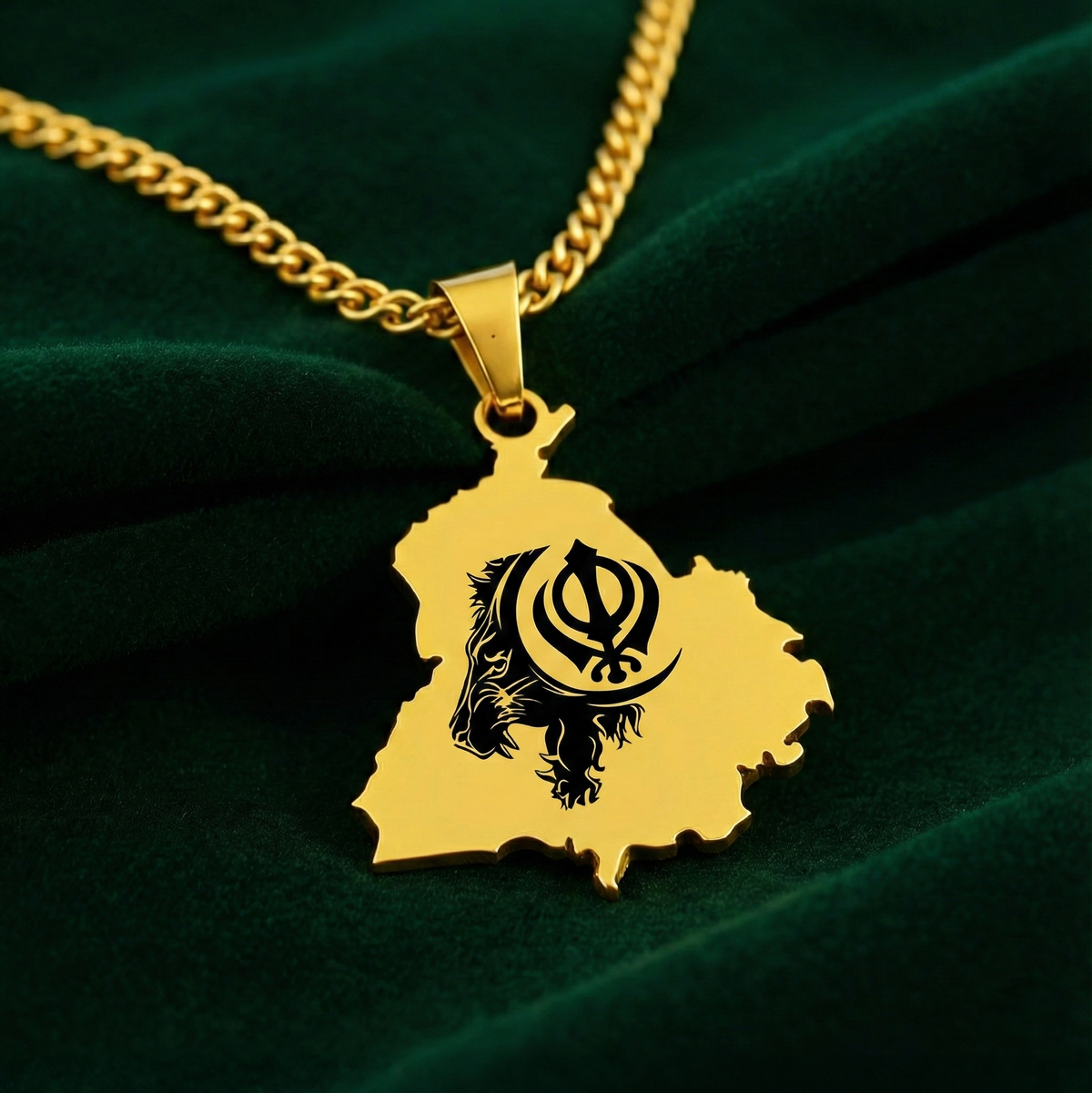 Gold-plated Punjab map pendant with a black Khanda design on a curb chain, on green velvet