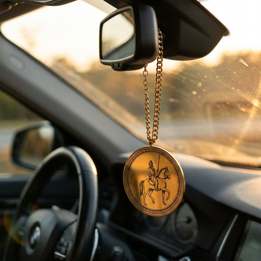 Sikh horse rider car hanging on a rear-view mirror at sunset