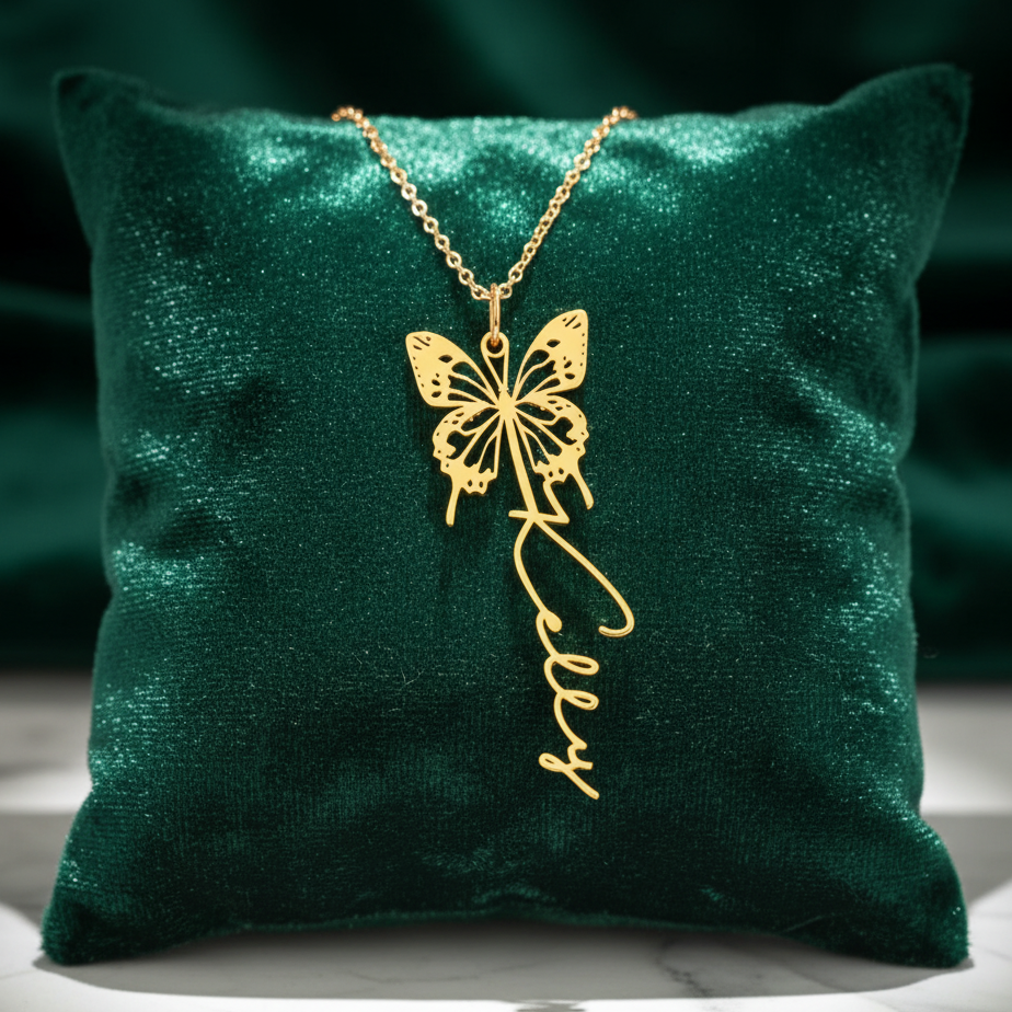 Gold butterfly necklace on a green pillow with a dark background