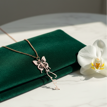 Butterfly necklace on a green fabric with a white orchid