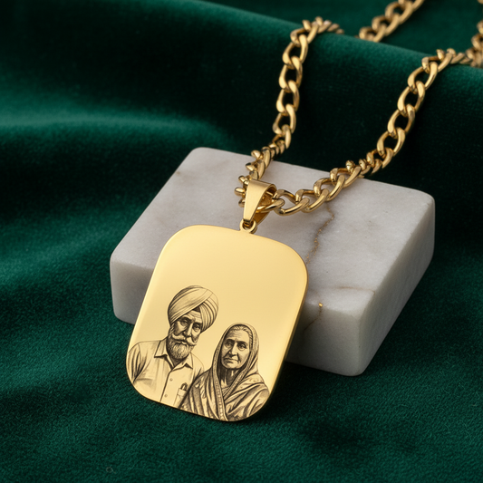 Gold necklace with a pendant engraved with two people on a green fabric background