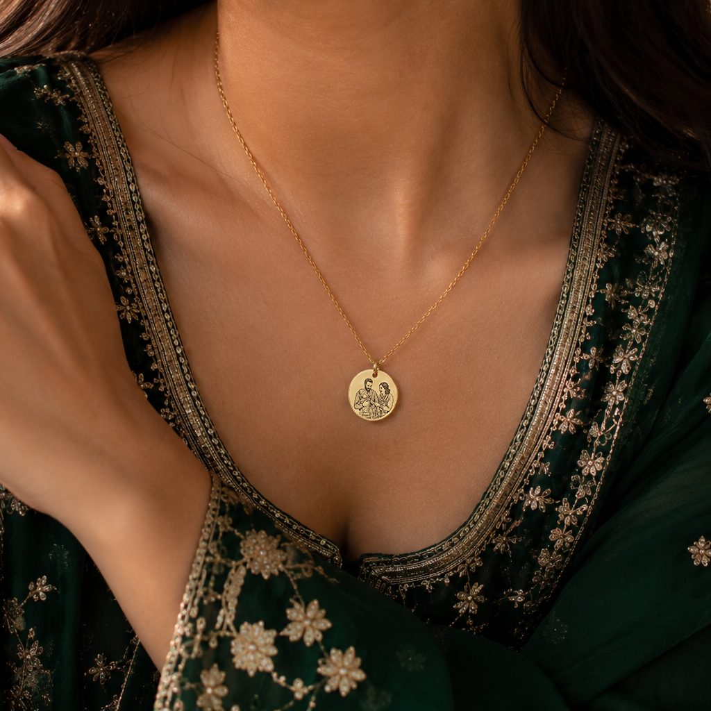 Woman wearing a green embroidered outfit with a gold necklace featuring a coin pendant.