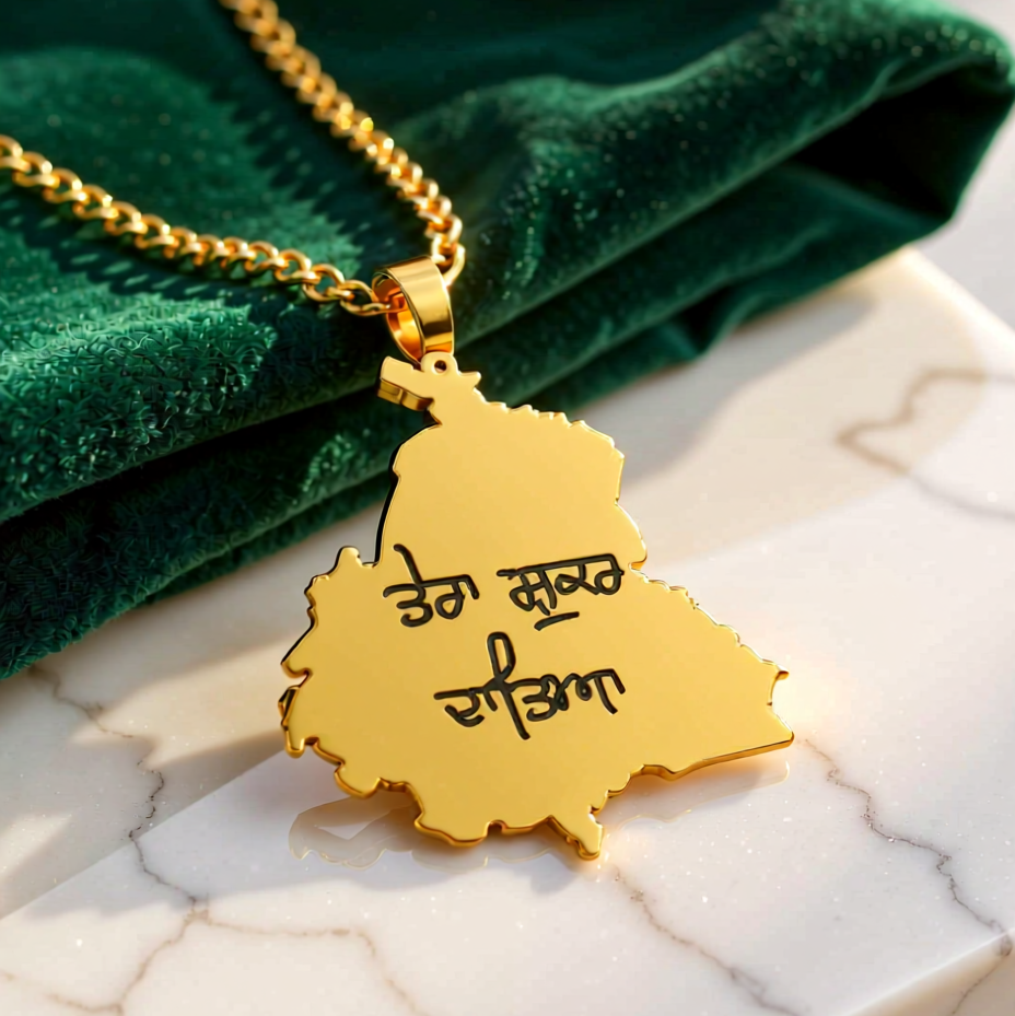 Gold necklace with a pendant on a marble surface