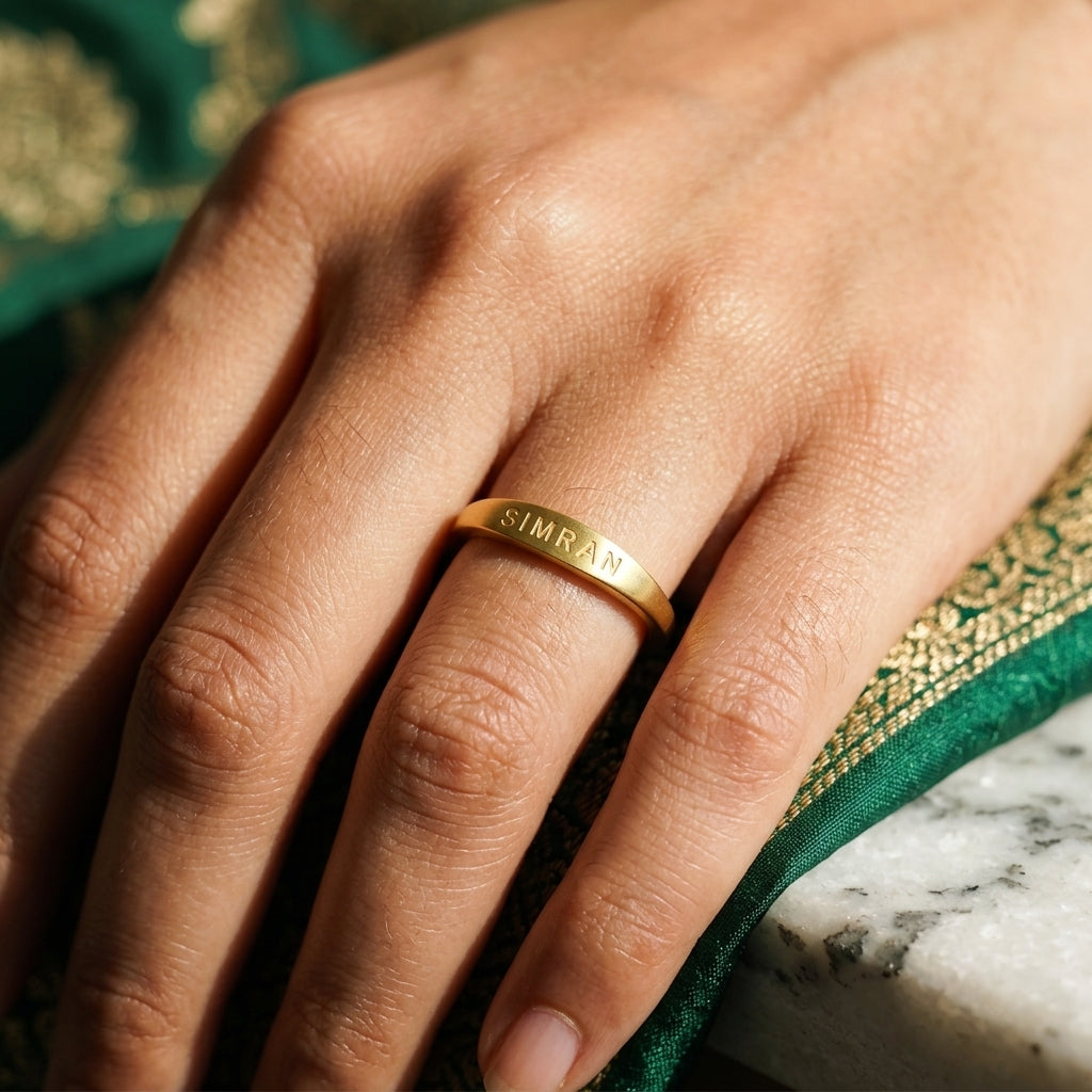 Slim gold name ring engraved SIMRAN worn on the finger
