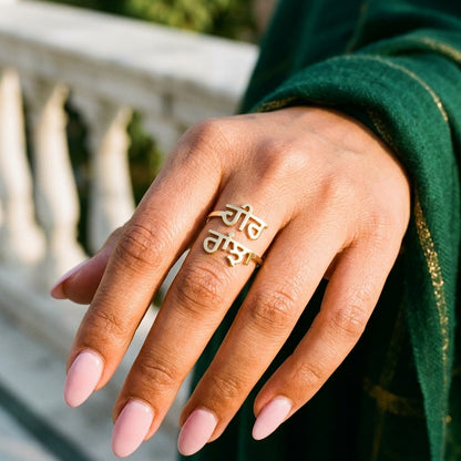 Gold double name ring with Punjabi names Heer and Ranjha on a woman's finger