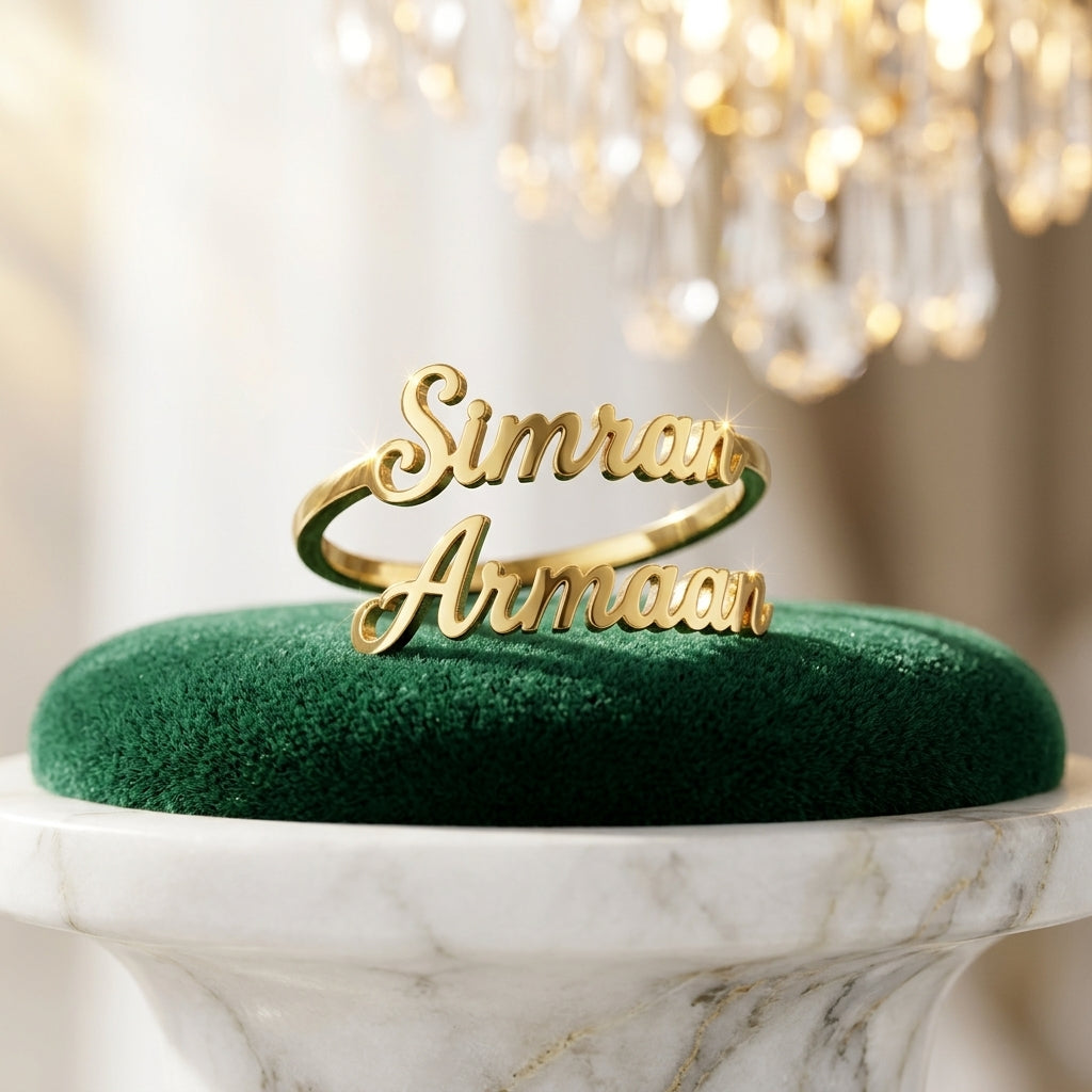 Gold double name ring with Simran and Armaan on green velvet