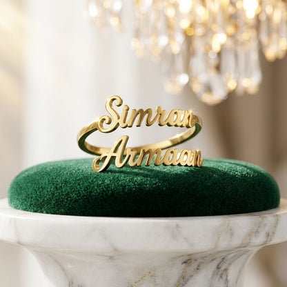 Gold double name ring with Simran and Armaan on green velvet