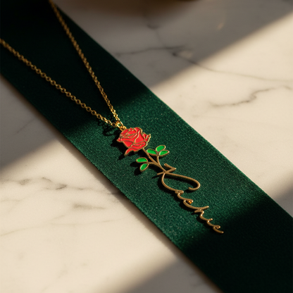 Necklace with a red rose pendant on a green ribbon against a marble background