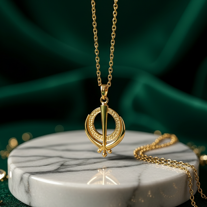 Gold necklace with a circular pendant on a marble stand against a green fabric background