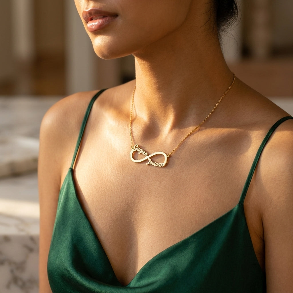 Gold infinity necklace with the names Gagan and Jeewan worn on the neck