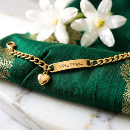 Gold heart charm name bracelet on green silk with white flowers