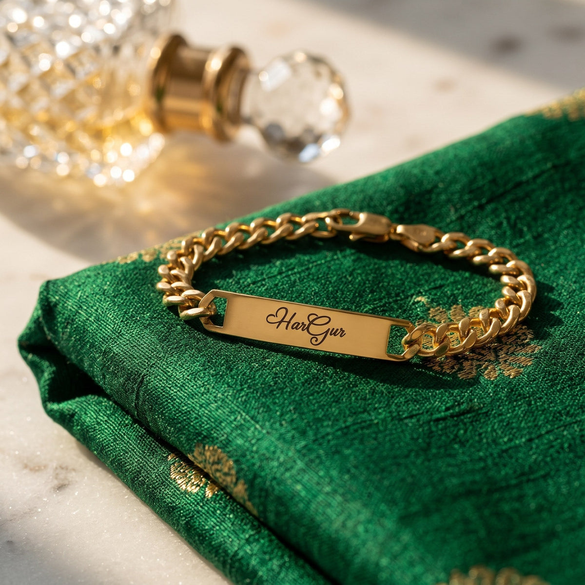 Gold name ID bracelet with HarGur closed on green silk