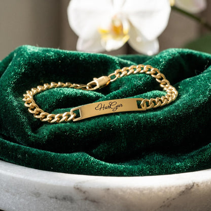 Gold name ID bracelet with HarGur closed on green velvet