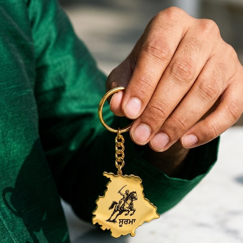 Soorma Punjab map keychain held in a hand
