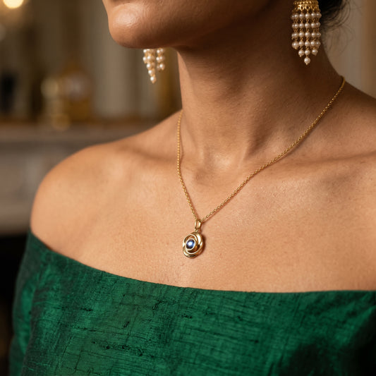 Gold rose projection necklace worn with an off-shoulder green top